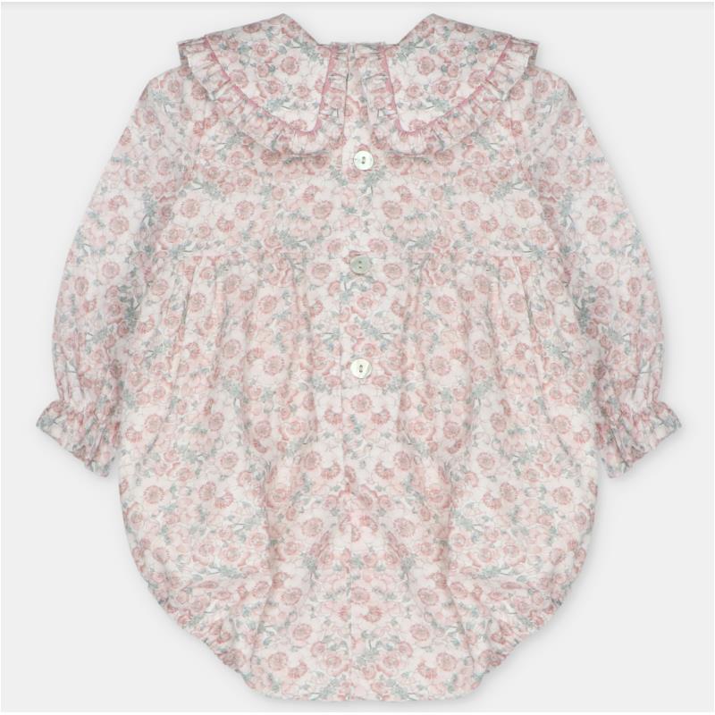 Baby girl short romper in woven fabric, featuring a floral pattern and ruffled collar, with button closure.