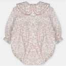 Baby girl short romper in woven fabric, featuring a floral pattern and ruffled collar, with button closure.