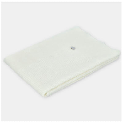 Ivory Draylon sweaterknit blanket from Martin Aranda, featuring a textured weave and small decorative button detail.