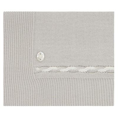 Stone-colored Draylon Sweaterknit Blanket with a decorative white knit band and a silver button detail.