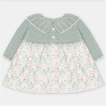 Martin Aranda dress featuring a sweater knit top in light gray and a floral fabric skirt with pastel colors.