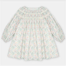 Woven green dress with a floral pattern, featuring a smocked neck and puff sleeves.