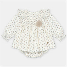 Woven beige dress and bloomer set with tree patterns and a decorative pom-pom, suitable for children.