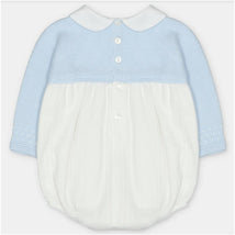 Short romper in a sweater knit and fabric mix, featuring a light blue top and white bottom with a collar and button details.