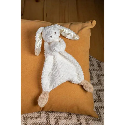 Oatmeal Bunny Lovey by Mary Meyer, featuring a soft white bunny with floppy ears and tan feet, resting on an orange pillow.