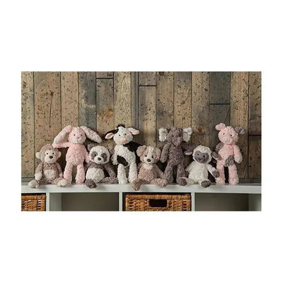 Mary Meyer Putty Nursery Character Blanket featuring a piglet among a collection of plush animal toys on a shelf.