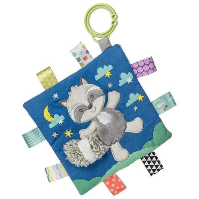 Soft baby blanket featuring a playful raccoon design with crinkle material and colorful tags, ideal for sensory exploration.