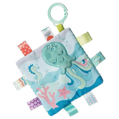 Soft fabric square featuring an octopus, seahorse, and starfish with colorful tags and a ring for attachment.