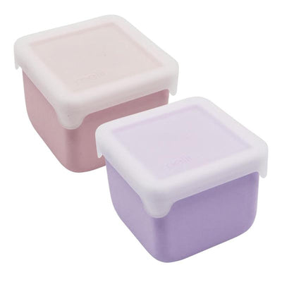 Two square silicone snack containers in pink and purple, each with a white lid, designed for snacks and food storage.
