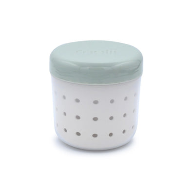 Melii Fruit Storage Container in sage and ivory, featuring a strainer design with small perforations for ventilation.