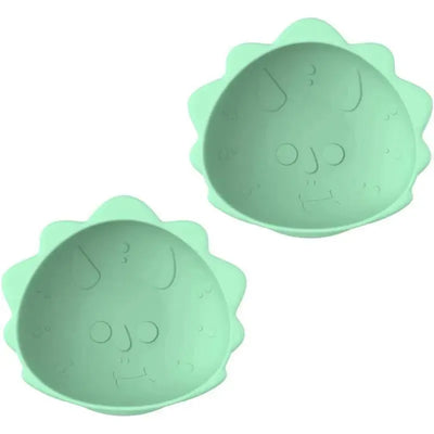 Silicone suction bowls for babies and toddlers, shaped like dinosaurs, in a soft green color.