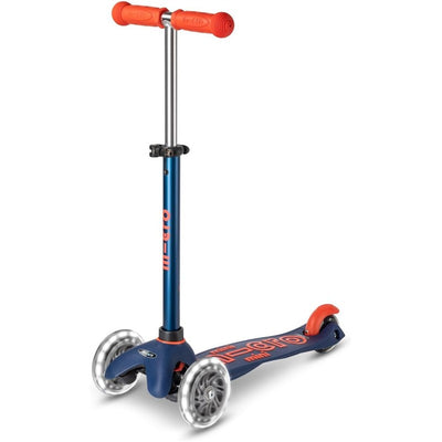 Navy blue Micro Kickboard Mini Deluxe LED Scooter with orange handlebars and clear wheels. Ideal for young riders.