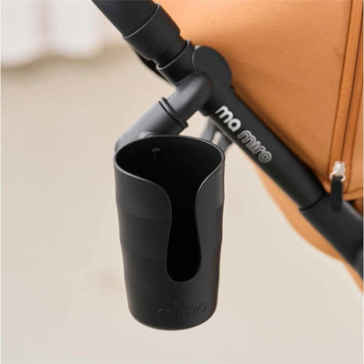 Mima Miro Cup Holder in black, mounted to a stroller, designed for holding drinks securely while on the go.