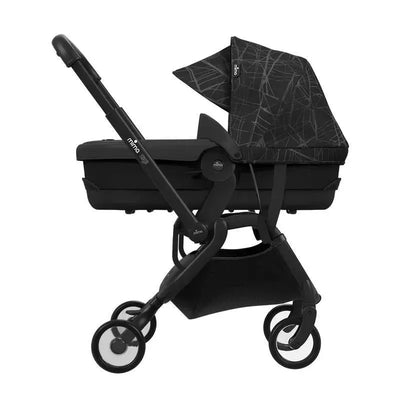 Mima Zigi carrycot in ebony with a black patterned canopy, mounted on a sleek stroller frame.