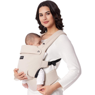Mom holds a sleeping baby in a khaki Momcozy baby carrier, showcasing comfort and support for newborns to toddlers.