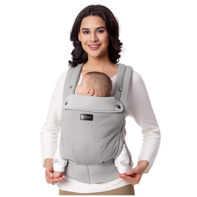 Momcozy mesh grey baby carrier being worn by a smiling woman, securely holding a newborn facing her.