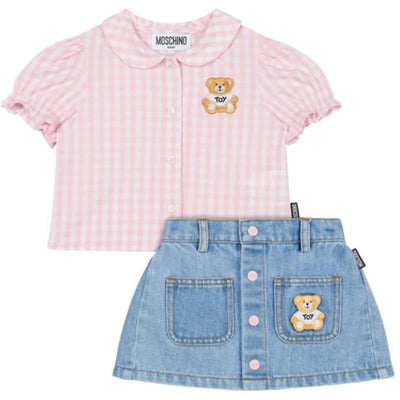 Short sleeve pink gingham blouse with bear patch, paired with a denim skirt featuring bear patch and button details.