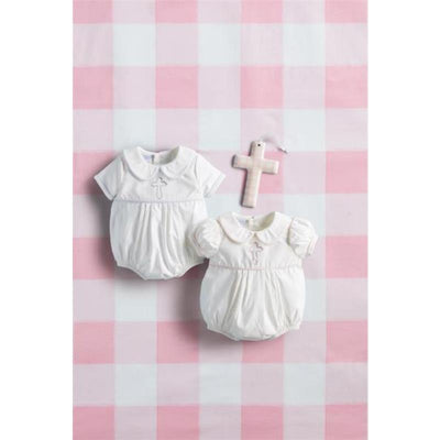 Baby girl cross poplin bubble outfits in white, featuring decorative crosses, on a pink checkered background.