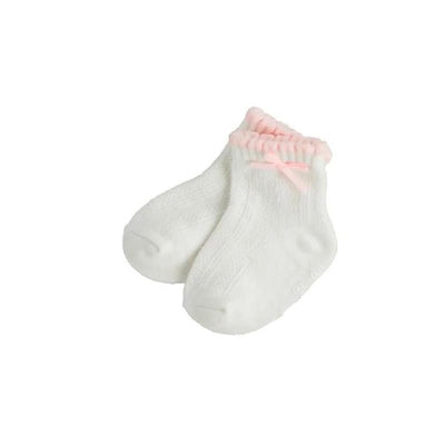 Ivory baby socks with pink trim and bow, designed for girls, featuring a soft, knitted texture.