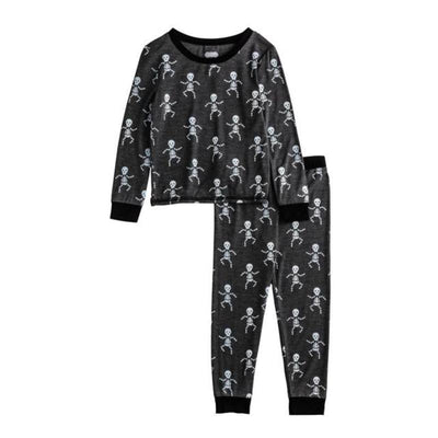 Toddler pajamas featuring a black background with playful skeleton prints, long sleeves, and matching pants.