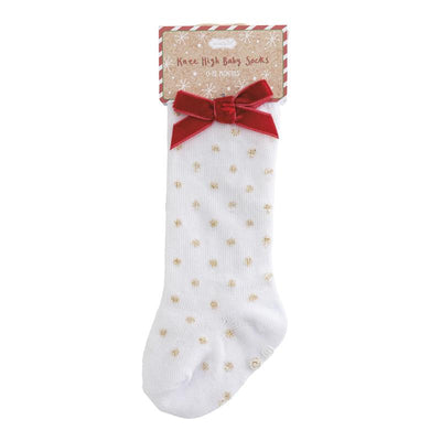 Knee-high white baby socks for 0-12 months with gold dot patterns and a red velvet bow at the top.