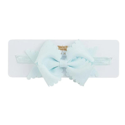 Light blue scallop bow headband by Mud Pie displayed on a white card, featuring soft fabric and a secure band.