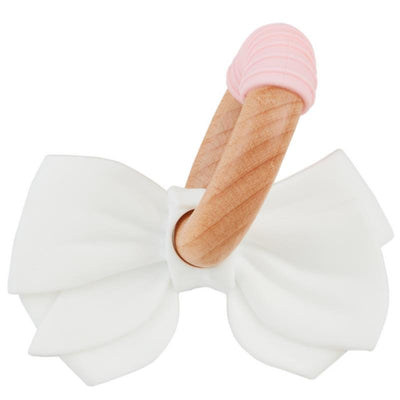 White silicone bow teething ring with a wooden handle and pink silicone tip, designed for infants to soothe teething discomfort.