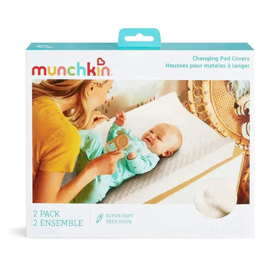Munchkin 2-pack diaper changing pad covers in white, featuring a baby lying on a changing table with a caregiver.