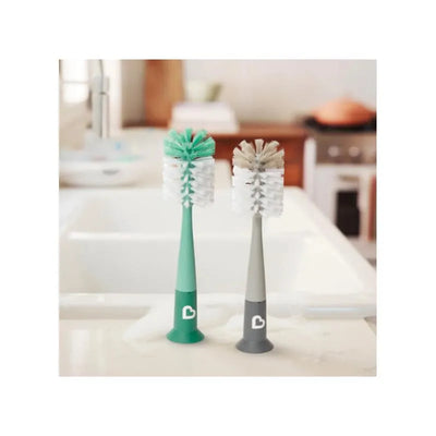 Bristle bottle brush set featuring a green and gray brush with soft bristles for cleaning bottles, placed on a kitchen countertop.