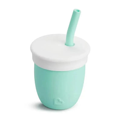 Munchkin C’est Silicone! training cup in mint green, featuring a white lid and straw for easy drinking.