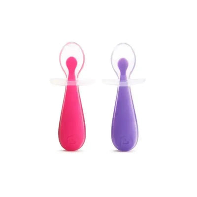 Silicone training spoons in pink and purple, designed for toddlers, with rounded soft tips for gentle feeding.