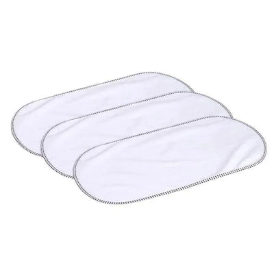 Three rectangular Munchkin waterproof changing pad liners stacked together, featuring a white surface and black edging.