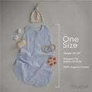 100% organic cotton muslin baby wearable blanket in light blue, accompanied by a beige hat, toy, and teething rings.
