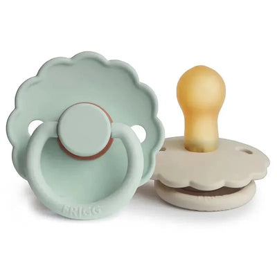 Natural rubber pacifiers in seafoam and cream colors, featuring a daisy design and suitable for ages 6-18 months.