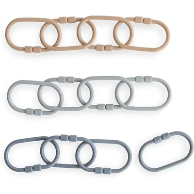 Mushie Chain Link Rings in natural beige and shades of gray, featuring flexible oval shapes with joined links.