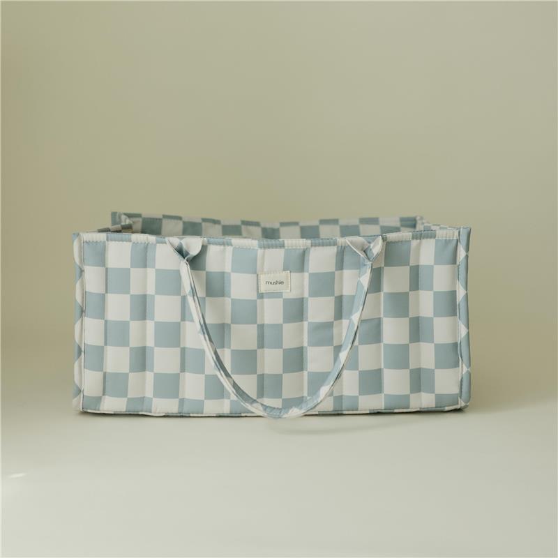 Mushie Baby Diaper Caddy in blue check pattern, designed for organizing newborn essentials, with side handles.