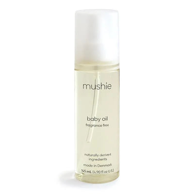 Mushie baby oil, 145 ml, fragrance-free, with naturally derived ingredients, in a clear bottle with a white pump.