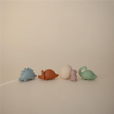 Mushie Dino Mold Free Bath Play Set - 4 colorful dinosaur figures and one egg, designed for playful bath time activities.