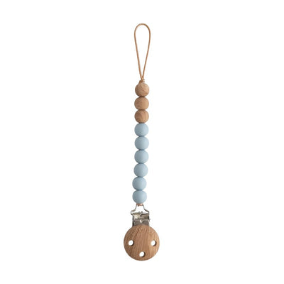 Mushie Eva Pacifier Clip in cloud color, featuring soft blue silicone beads and a wood clip for securing pacifiers.