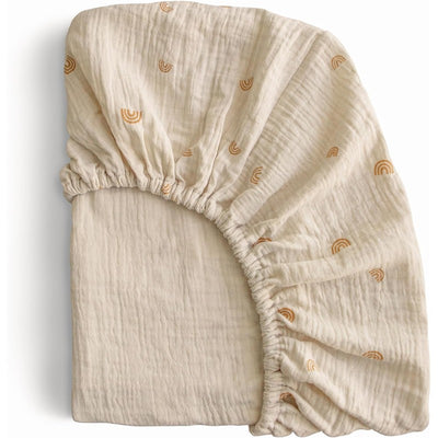 Extra soft organic muslin crib sheet featuring a subtle rainbow pattern, ideal for nursery use.