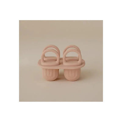 Silicone ice pop tray for toddlers featuring two compartments and handles, presented in a blush color.