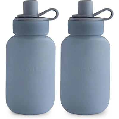 Mushie Puree Pouch in Tradewinds, featuring two blue silicone bottles with soft lids for easy use.