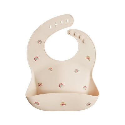 Silicone baby bib featuring a soft beige color adorned with colorful rainbow patterns, designed for easy cleaning.
