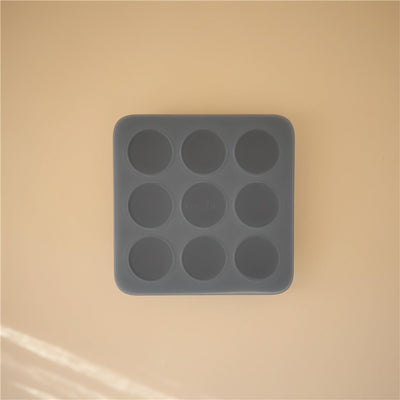 Silicone baby food freezer tray with nine circular compartments, designed for easy portioning and storage.