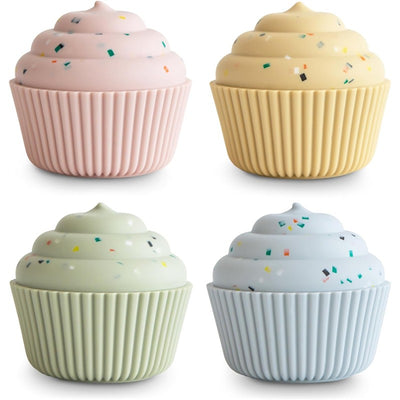Mushie Silicone Mix and Match Cupcake Toy 4-Pack featuring pastel-colored cupcake shapes with frosting and sprinkle details.