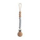 Mushie Eva Pacifier Clip in Stone color, featuring wooden and silicone beads and a metal clip for securing pacifiers.