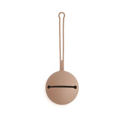 Mushie natural silicone pacifier holder case, round shape with a loop handle, designed to store pacifiers securely.
