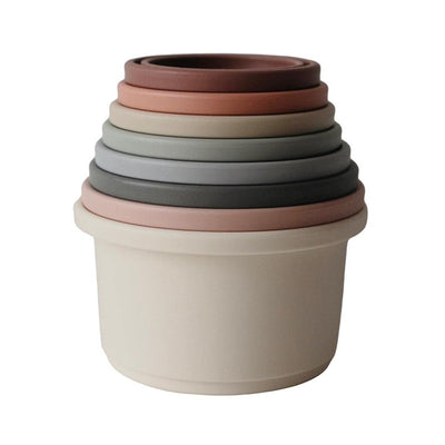Mushie Stacking Cups set featuring six interlocking cups in soft pastel colors, designed for learning and play.