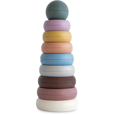 Multi-colored Mushie stacking rings in a tower, featuring a round mint green top ring and various pastel base rings.