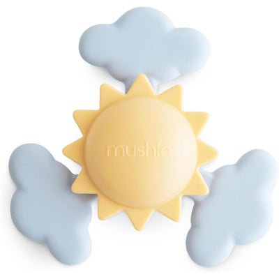 Mushie Sunshine Suction Spinner Toy in soft yellow and blue, featuring a sun surrounded by two cloud shapes.